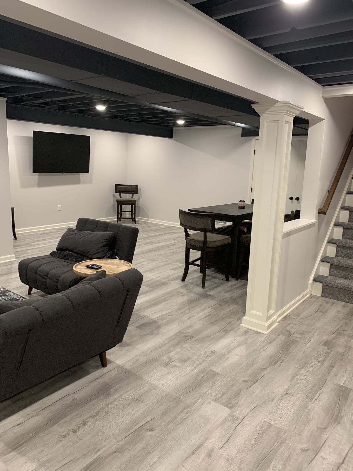 Finished luxury basement lounge with pool table, stone fireplace and reclaimed wood wall
