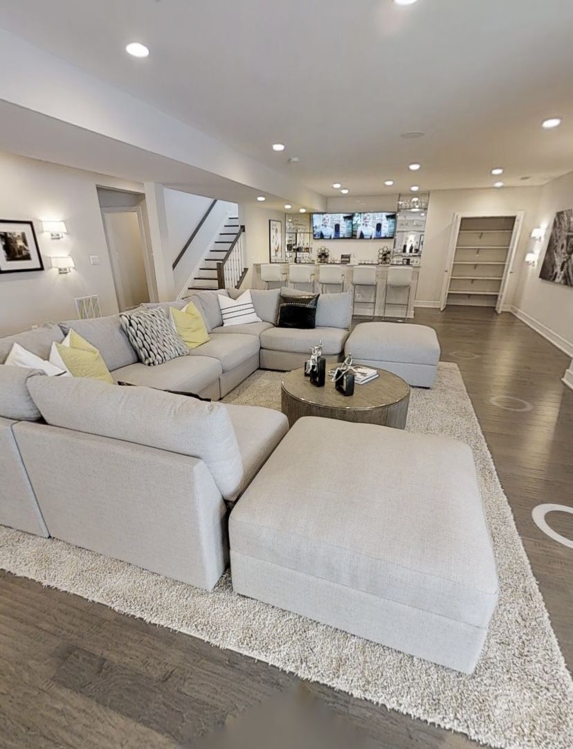 Finished luxury basement lounge with pool table, stone fireplace and reclaimed wood wall
