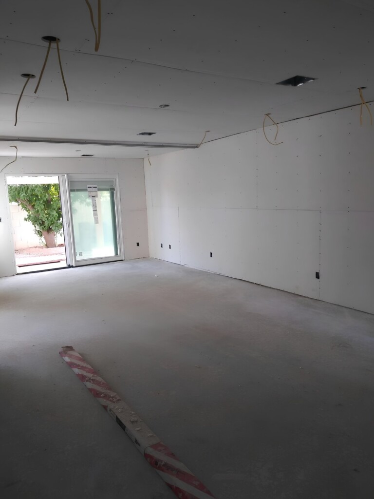 New drywall installed around a patio door before finishing