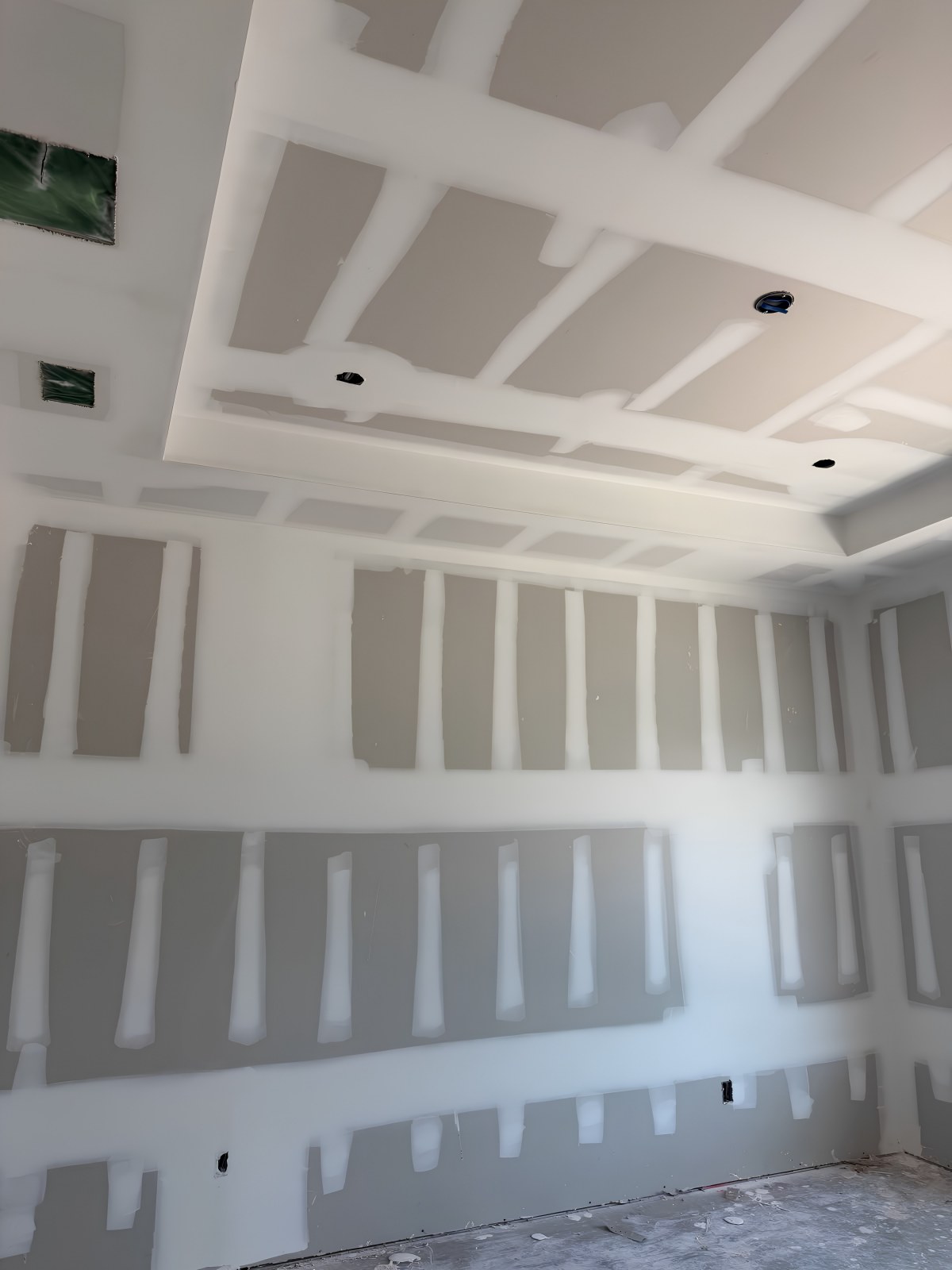 Drywall installation in Norfolk County — room with a tray ceiling, seams taped and mudded