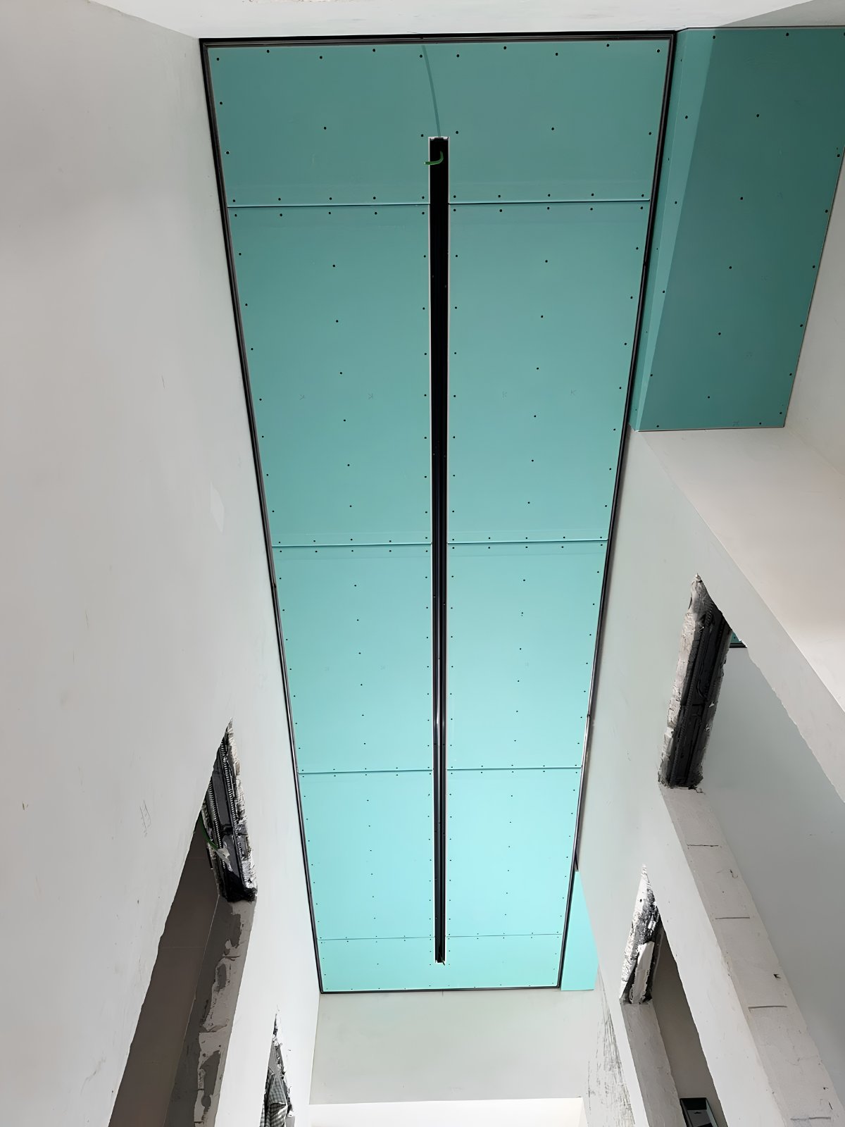 Drywall installation in Waterloo Region — vertical light-shaft ceiling