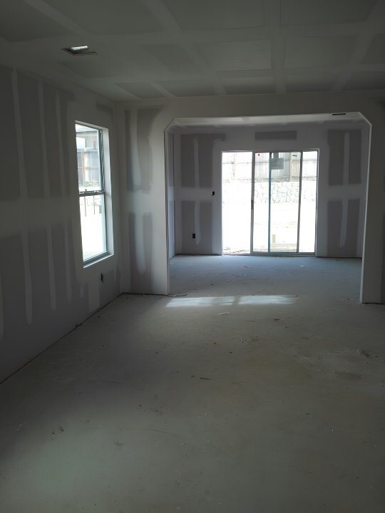 Drywall installation in Durham Region — open-plan room with archway