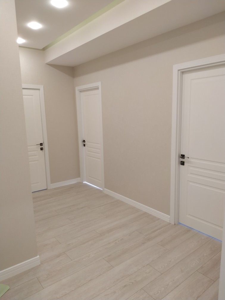 Fresh basement suite hallway with bedroom and bathroom doors