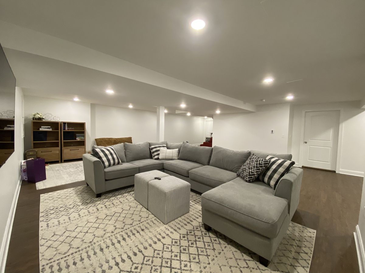 Basement suite rec room with large grey sectional