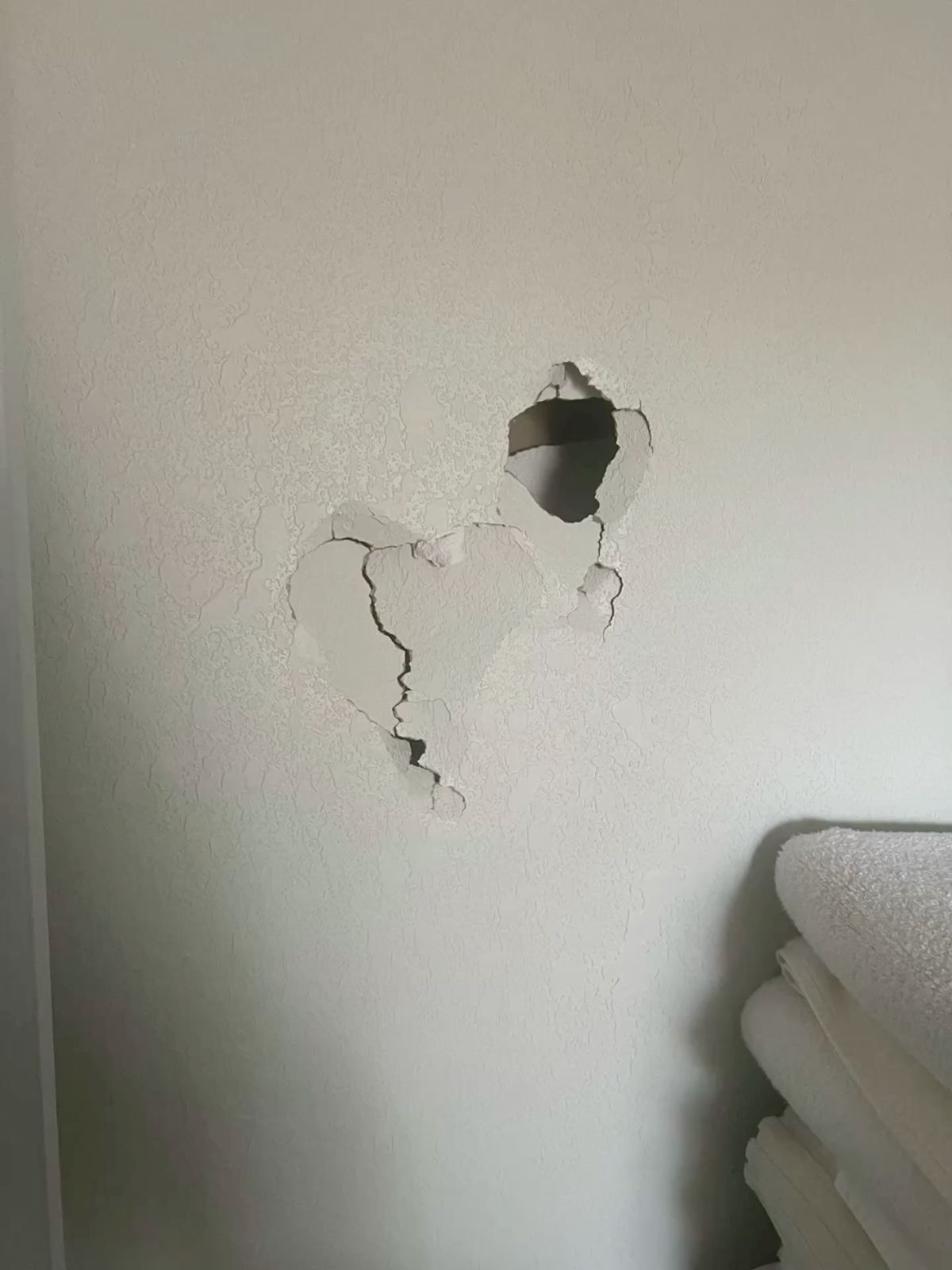Cracked drywall impact damage in a Mississauga hallway closet in Mississauga