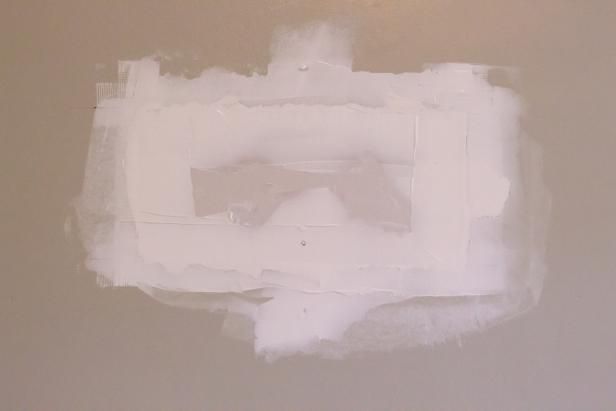 Mesh tape and joint compound over a drywall patch in a Perth County home in Perth County