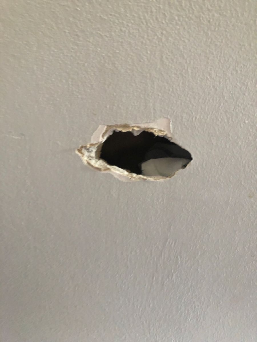 Punched hole in a Brampton bedroom wall before drywall repair in Brampton