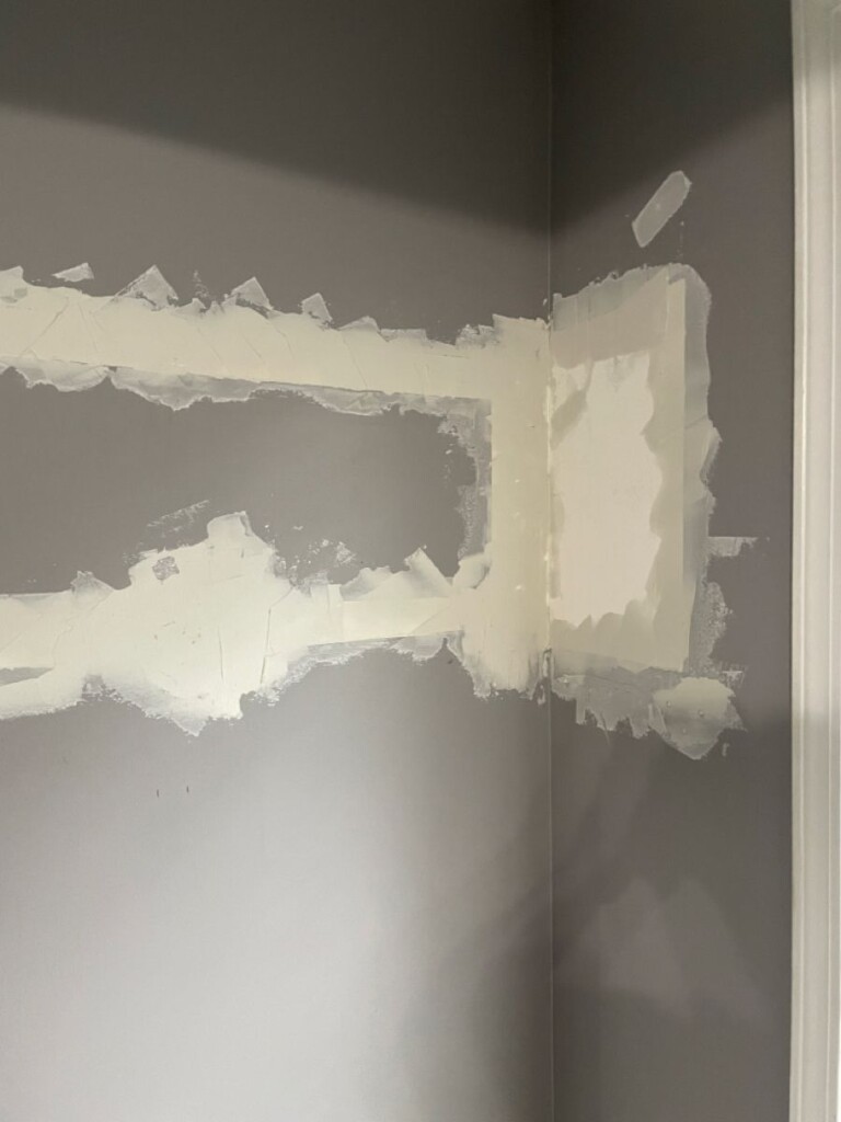 Repaired and primed drywall section on an interior wall