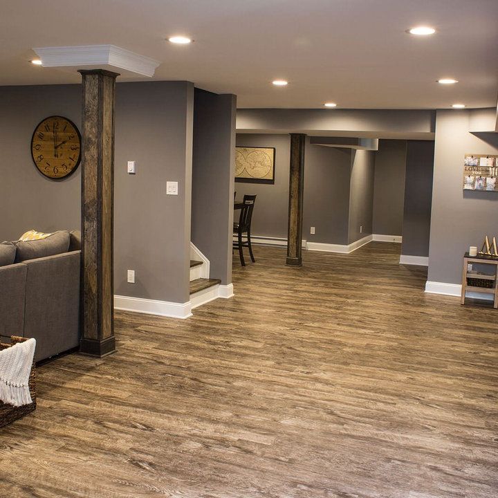 Open-plan grey basement apartment with dining corner