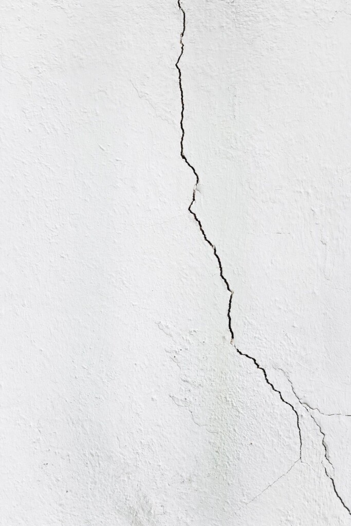 Textured plaster wall with a crack before repair