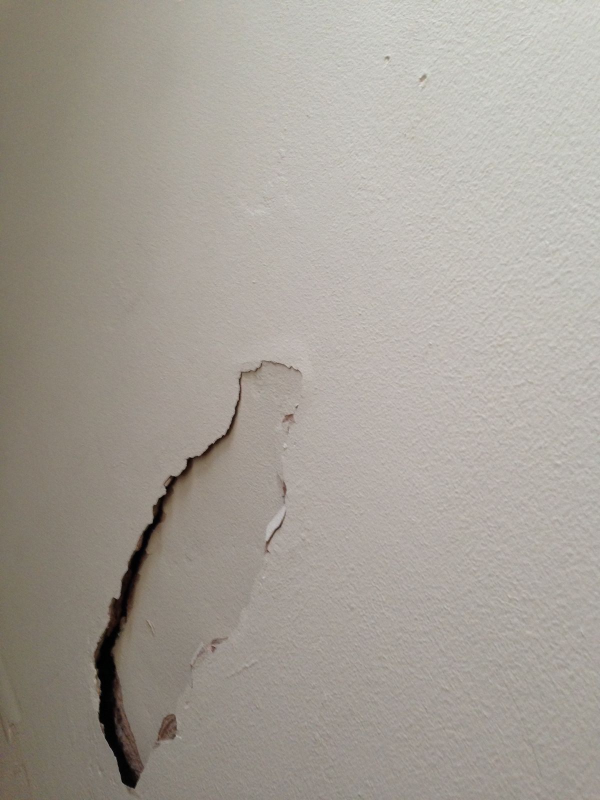 Torn drywall gash awaiting repair in a Peel Region home