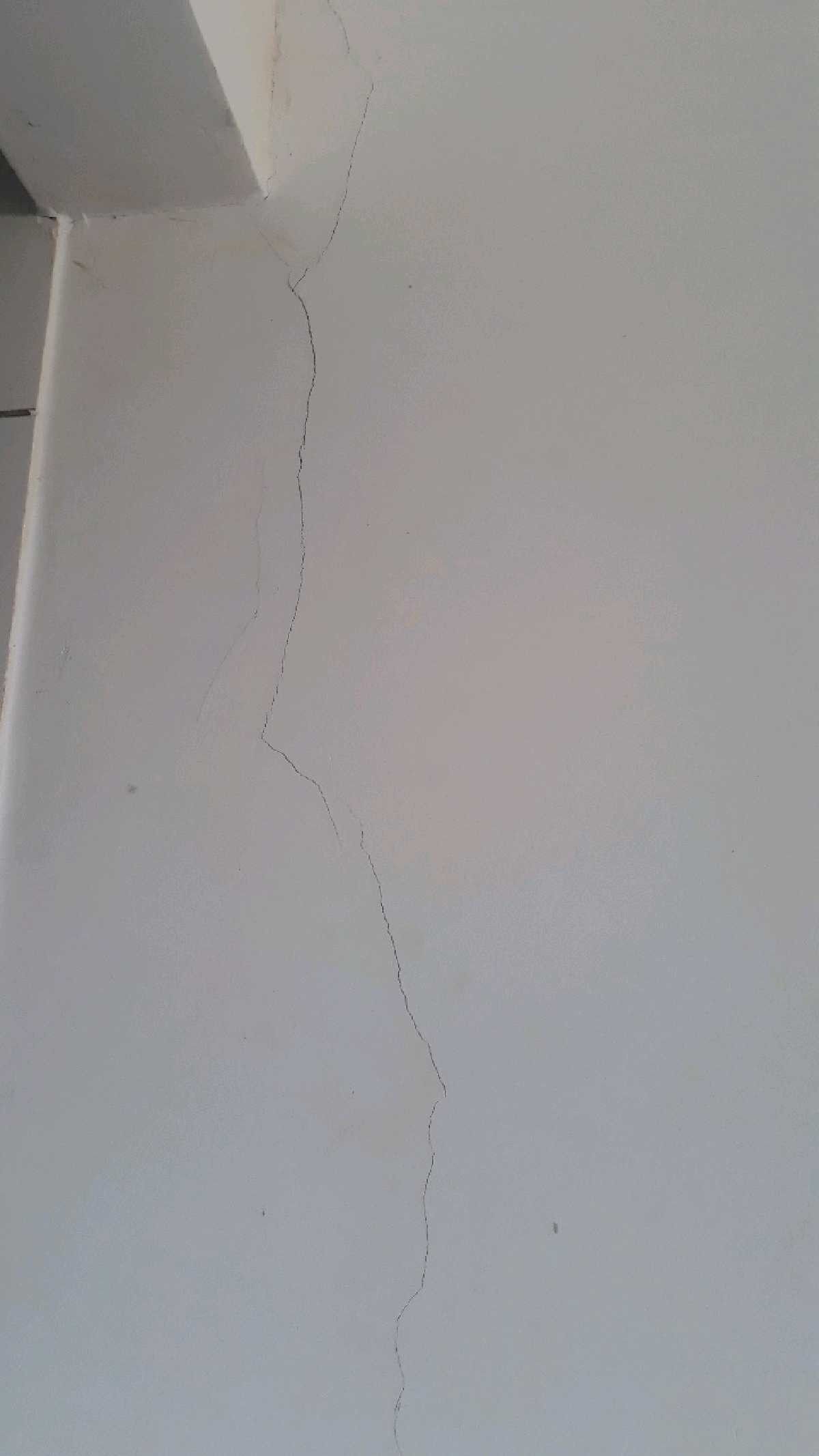 Feathered drywall patch sanded flush and primed in a Wellington County home